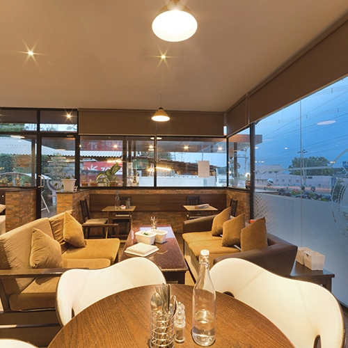 Elegant café interior with cozy sofas, warm lighting, and modern decor for a welcoming vibe.