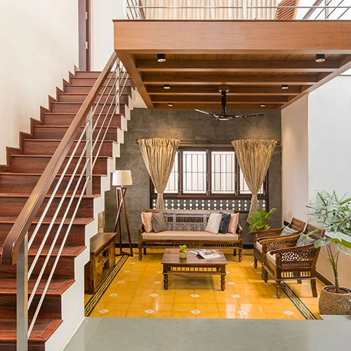 Elegant interior with cozy seating, wooden staircase, and vibrant flooring for a stylish look.